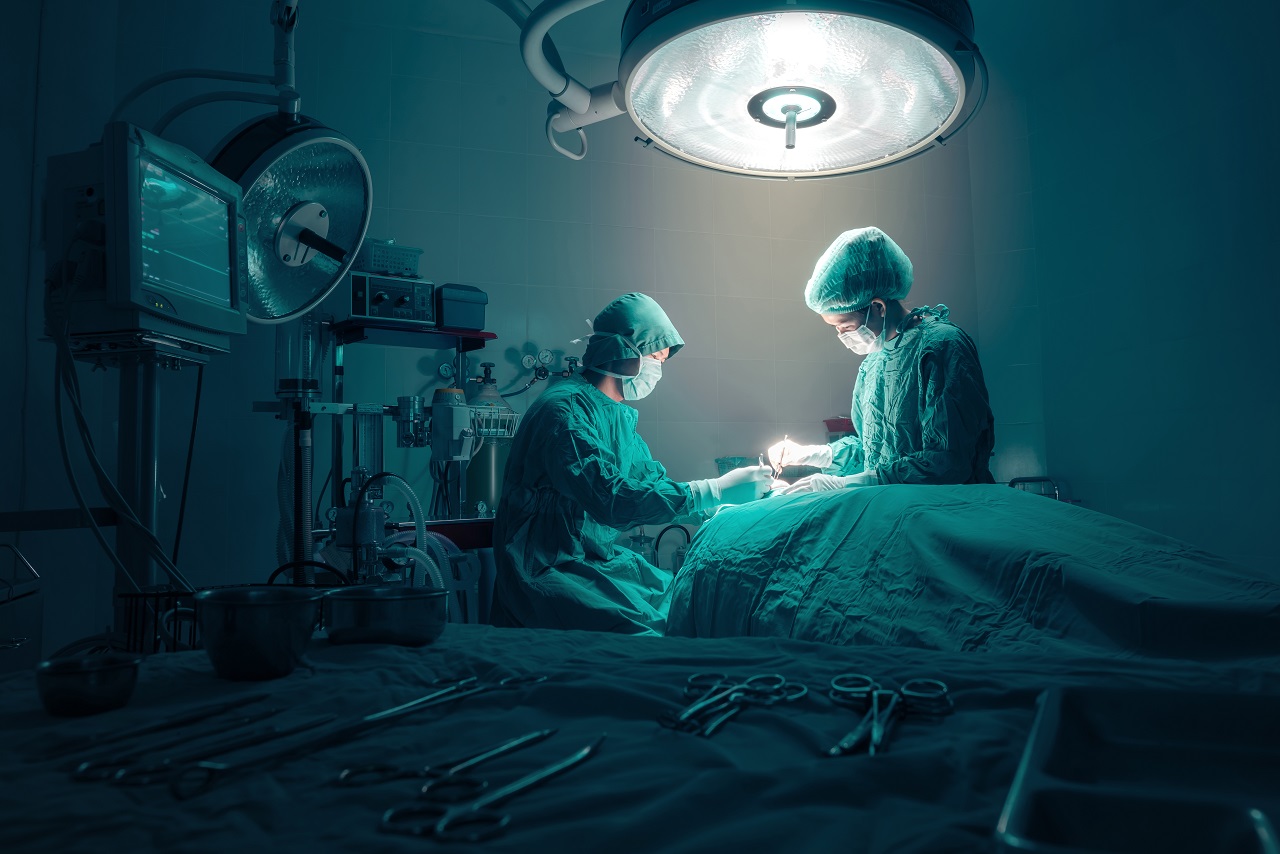 Two surgeons operating on a patient