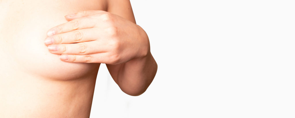 A woman cover her breast