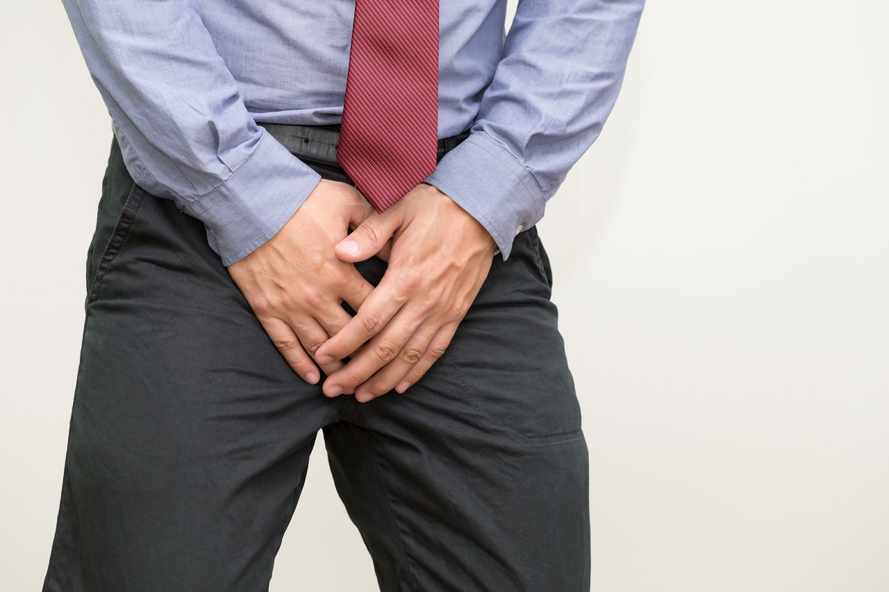 A man holding his prostate in pain