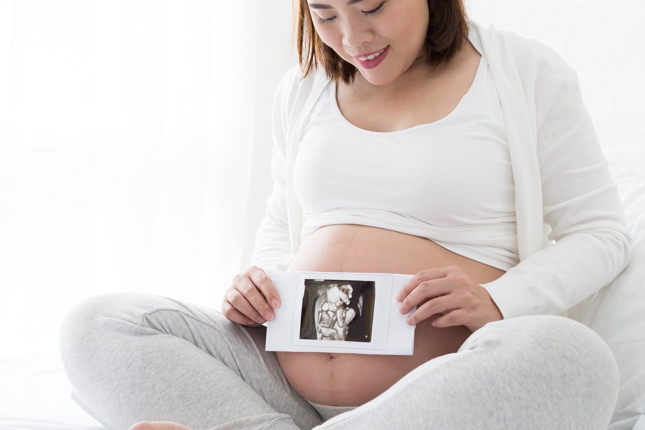 A mother holding the results of her 4D ultrasound