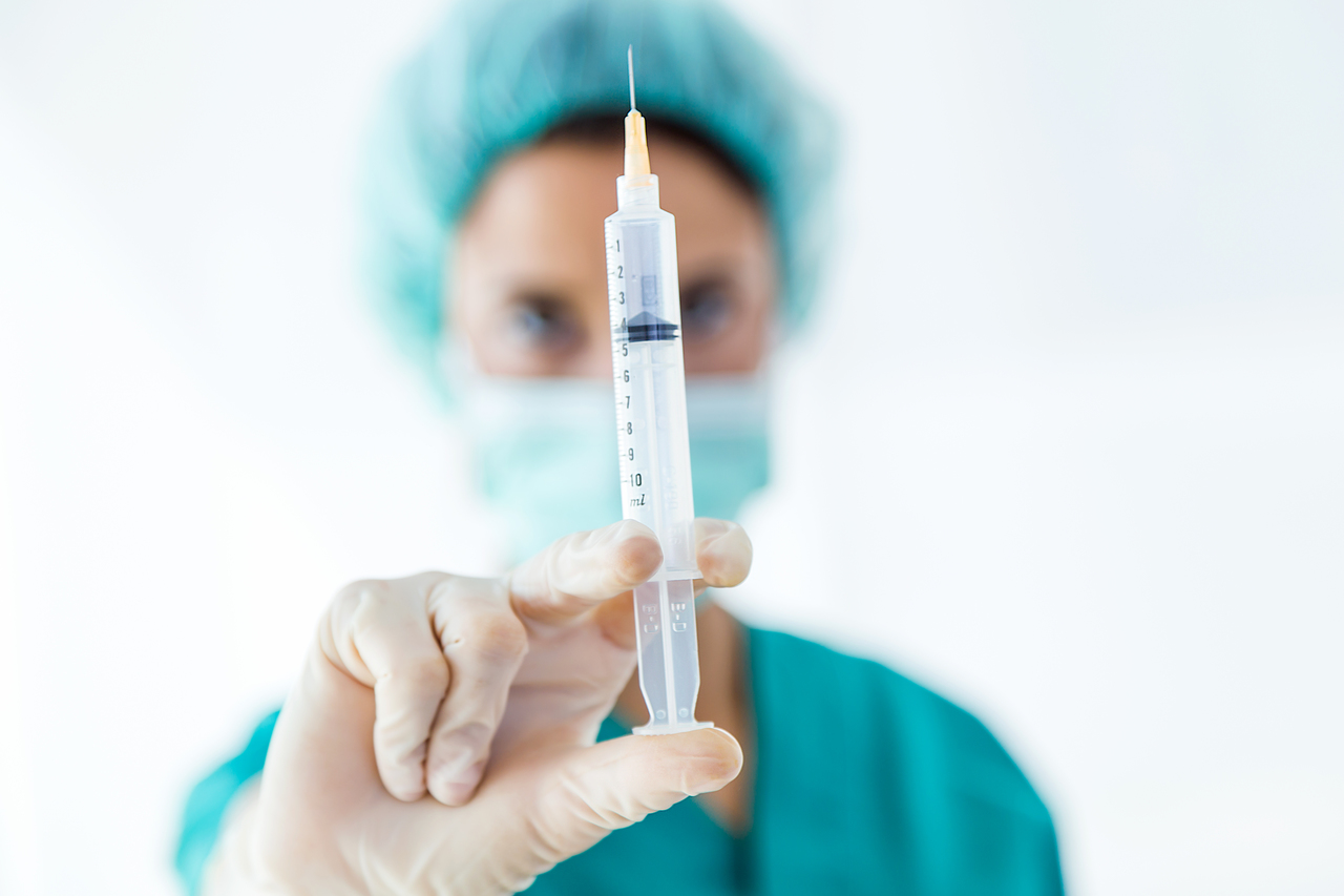 A doctor with a big needle