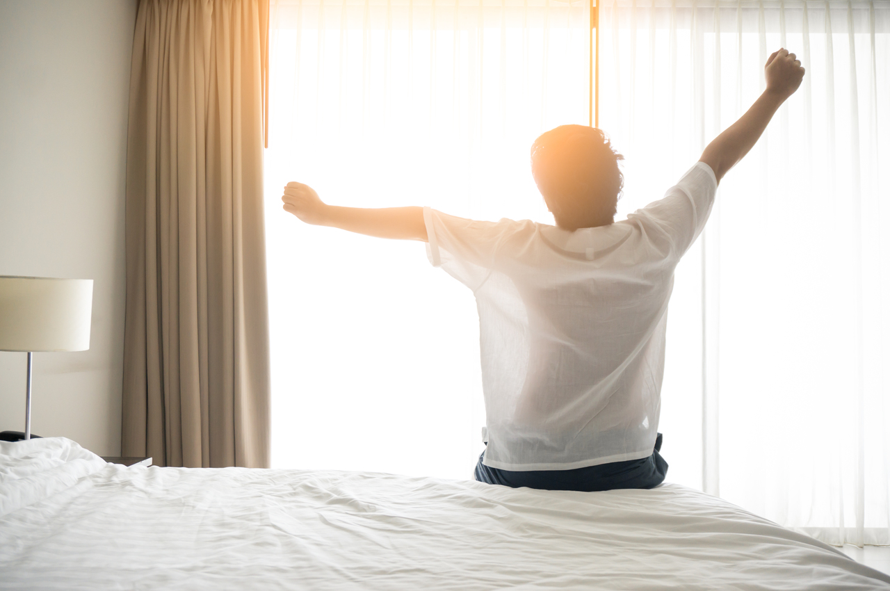 A man waking up after a good night's rest