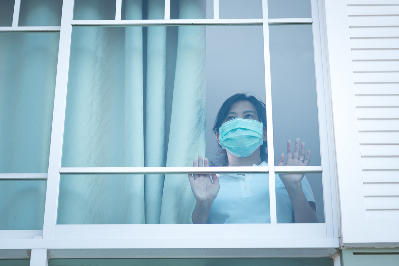 A woman self-isolating in her home