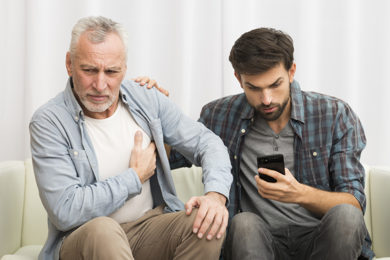 A son calmly calling an ambulance for his father having a seizure